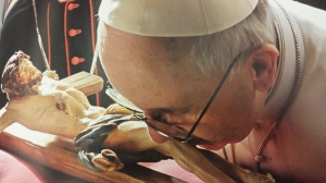 Pope Francis having a "special time" kissing an idol.